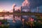 Nature\\\'s embrace, Lotus plants surround thermal power plant, colorful cloudy sky