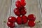 Nature's Oddity: ugly, irregularly shaped cherry stands out against a rustic wooden backdrop