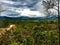 Nature sandstone pai canyon rain forest trees hills cliffs rocks fields green background mountains hills clouds sky sun