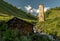 Nature scenery of Caucasus Svaneti landscape with old medieval defense stone tower, the mountain range, glacial stream, green mead