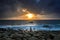 Nature Seascape with Zen Stacked Rocks on Beach in Little Sunshine at Dawn