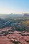 Nature shot of sloping rock leading into forest and road towards the horizon