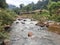 Nature view of stream, rock, mountain, cloud, fog and small viillage in Nan province which is in the north of Thailand