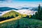 Nature wakes up after a cold summer night in the mountains. Splendid morning in Carpathians. Bright sunny scene of mountain valley