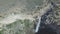 Nature, waterfall and drone in mountains with environment, landscape and top view of water. Rocky cliff, stream and