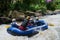 Nature will offer some of the best adventures. Shot of a group of young male friends white water rafting.