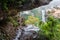 Natures window to a waterfall viewed through the cliff ledge