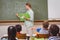 Naughty pupil throwing paper airplane in class