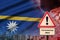 Nauru flag and Coronavirus 2019-nCoV alert sign. Concept of high probability of novel coronavirus outbreak through traveling