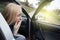 Nausea during a car trip. A blonde woman suffers from kinetosis. The concept of motion sickness in diseases of the transport and