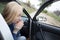 Nausea during a car trip. A blonde woman suffers from kinetosis. The concept of motion sickness in diseases of the transport and