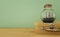 nautical concept image with sail boat in the bottle and old suitcase box over wooden table. Selective focus.