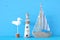 nautical concept with white decorative seagull bird, lighthous, and boat oars over blue background.