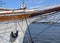 Nautical maritime scene with ropes and mast on a ship on a dock by the water