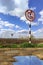 Nautical mark anchor installed on river bank. Meaning "No anchoring" - prohibition sign on bank canal. Forbidden to stop