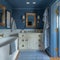 Nautical-themed bathroom with navy stripes and brass fixtures