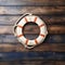 Nautical themed welcome Lifebuoy on textured wood background for custom text