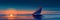 Nautical Twilight: Sailboat Against the Setting Sun - Suitable for Marine Travel, Nautical Themes, and Adventure