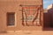 navajo rug hanging on an adobe wall outdoors