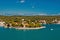 Naval storehouse and careening wharf in Mahon, Spain. Boats in sea harbor. Sea coast on sunny blue sky. Summer vacation