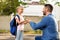 Navigating new beginnings. Father leading his daughter in first grade, holding hands and talking with child on backyard