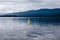 Navigating from Vancouver Island to Denman Island: flat sea, dramatic colors, yellow danger or warning buoy