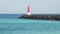 Navigation beacon on a stone breakwater.