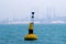 Navigation buoy at the entrance of a channel. Oil and gas marine industry as a background: Jack-ups, rigs...