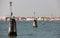 Navigation posts with lights marking waterway in the Venetian Lagoon