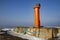 Navigation red lighthouse on Mangalsala pier in Baltic sea located at Riga sea port