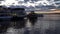 Navigation on the river in the evening. Motor ships, a tugboat and a pleasure boat. Golden sunset, pier.