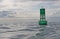 Navigational buoy in calm seas with clouds