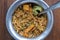 Navratan saffron biryani in metal pot on wooden background, top view, close up. Indian cuisine