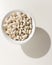 Navy Bean legume. Grains in a bowl. Shadow over white table.