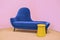 Navy blue sofa on a pink background, laconic interior