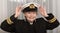 Navy Chaplin in uniform adjusting her hat