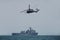 Navy helicopter and battleship