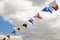 Navy ship signal flags against clouds.