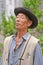 Naxi minority male singer performs in a garden, Lijiang, China