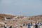 Naxian Lions statues on The Terrace of the Lions on the Greek island of Delos, people walk by