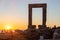 Naxos island, sunset over Temple of Apollo, Cyclades Greece. People admires the sundown background