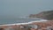 Nazare coast scene with oceanfront hotels and lighthouse on the rock, Portugal