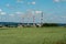 Nazarovskaya GRES with smoking chimneys in summer, seen behind a wheat field, is located in the city of Nazarovo, Krasnoyarsk