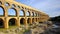 ncient Mastery: Roman Aqueduct Majesty Spanning the Gentle River