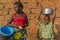 NDALATANDO/ANGOLA - 27 JUL 2017 - African mother and son in village in rural Africa with crockery.