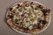 Neapolitan artisan pizza with mozzarella, sausage, black truffle, basil, black pepper and parmesan. Top view