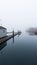 Near empty boating dock on a cold and misty morning