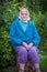 Near one hundred year woman sitting outdoors