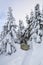 Near the tent, covered with snow. On the lawn covered with white snowflake there is a trampled path that lead to the dense forest.