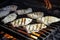 neat fish fillets cooking on a large, open stone grill